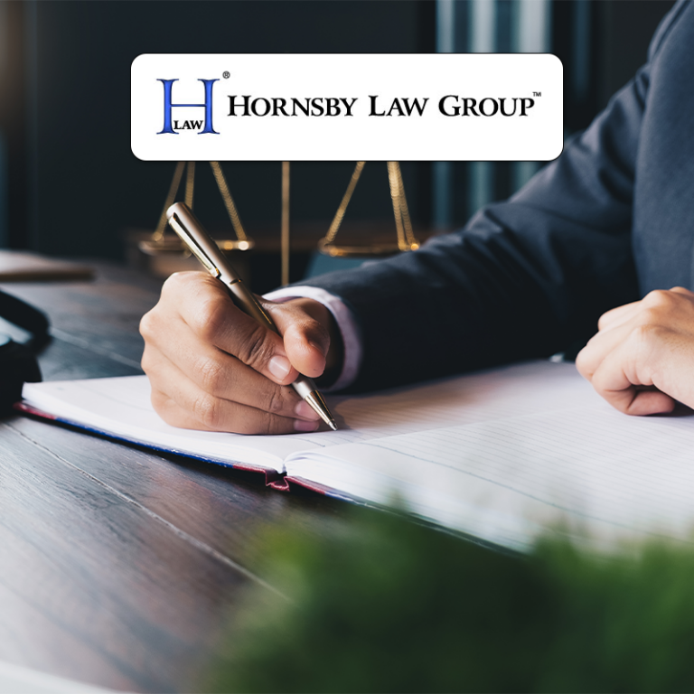Lawyer writing in a notebook at desk, scales of justice behind, Hornsby Law Group logo overlay