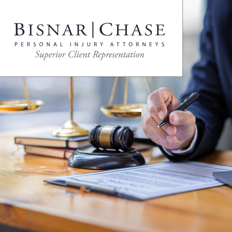 Lawyer signing documents at desk with gavel and scales, Bisnar | Chase Personal Injury Attorneys logo overlay