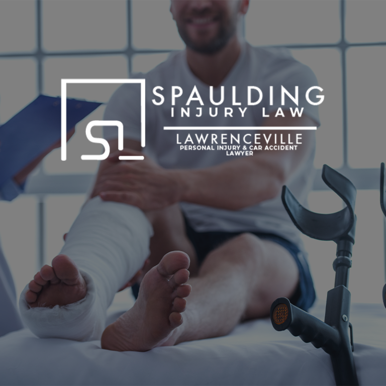 Injured patient with leg cast in clinic, forearm crutch, Spaulding Injury Law Lawrenceville logo overlay