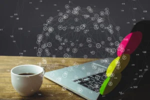 Laptop and coffee on a wooden desk with a connected digital network and app icons overlay
