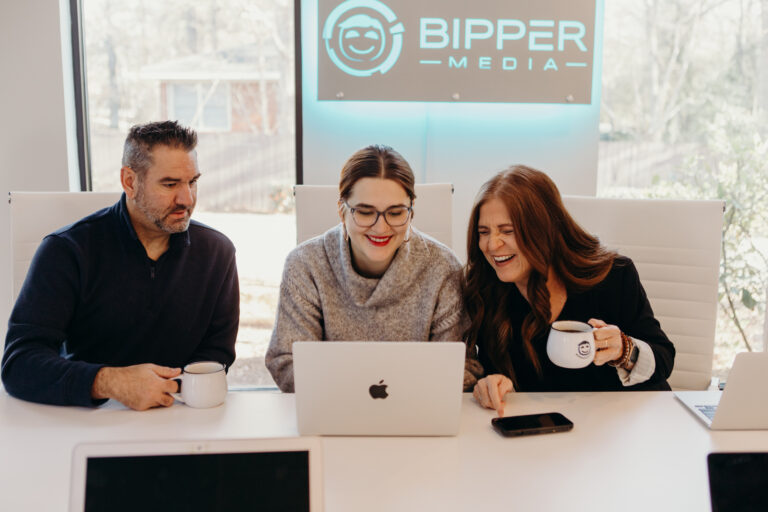 The image showcases a modern workspace featuring a laptop on a desk, symbolizing the tools essential for digital marketing professionals. This setup highlights the importance of effective communication and productivity in services like SEO and content management offered by Bipper Media.