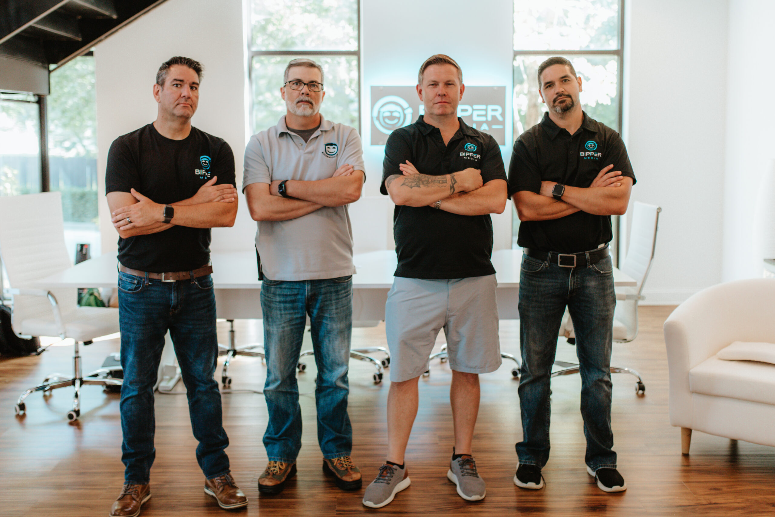 Summer Ready Website Conversion Checklist 2 The image features a group of individuals in a casual office setting, collaborating while seated around a desk. This reflects Bipper Media's emphasis on teamwork and collaboration in delivering effective digital marketing solutions.